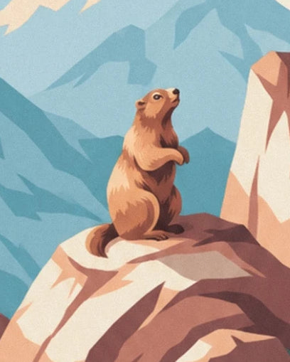 The marmot standing on a rock with its paws tucked in, against the blue mountains