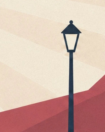 A tall, slender black street lamp in front of the red and cream canvas of the big top