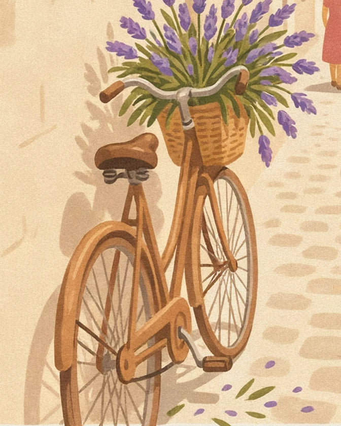 The ochre bicycle with its wicker basket overflowing with lavender, on the cobblestones