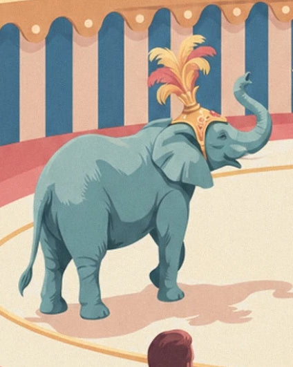 The elephant with its trunk raised, wearing red and yellow feathers in the ring
