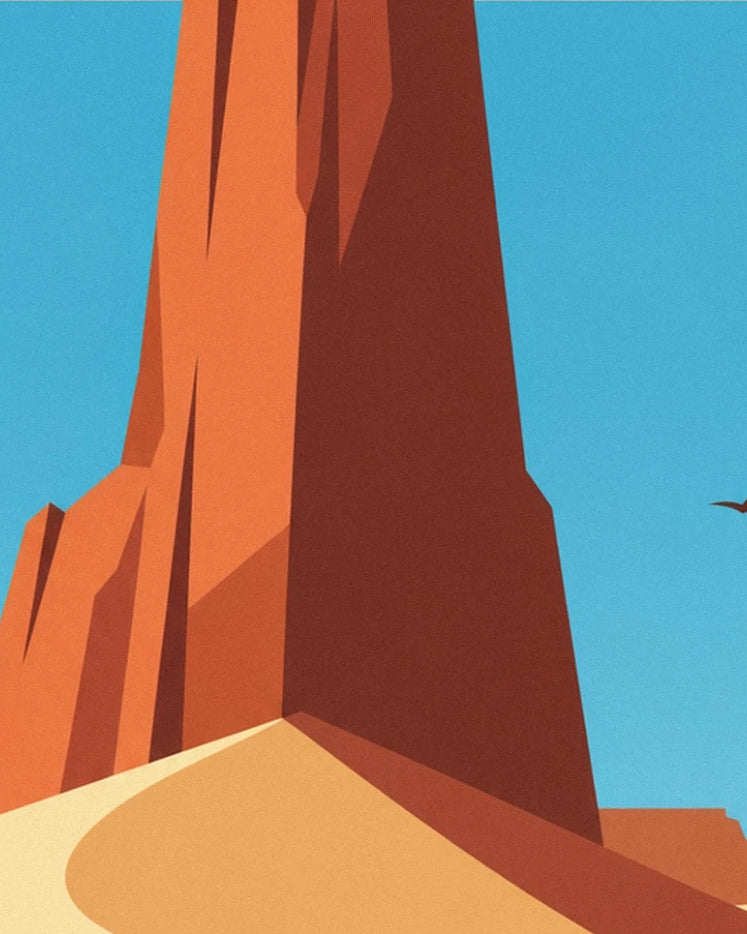 The red rock pillar rising beneath a blue sky, above the golden dune