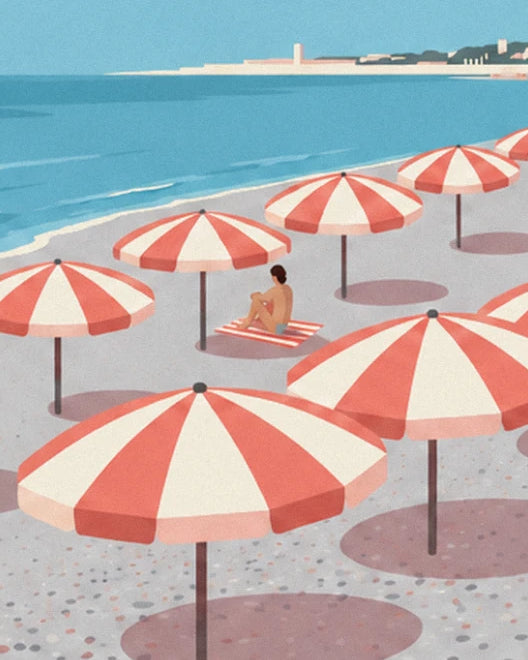 Bather sitting on a striped towel between the parasols, facing the sea