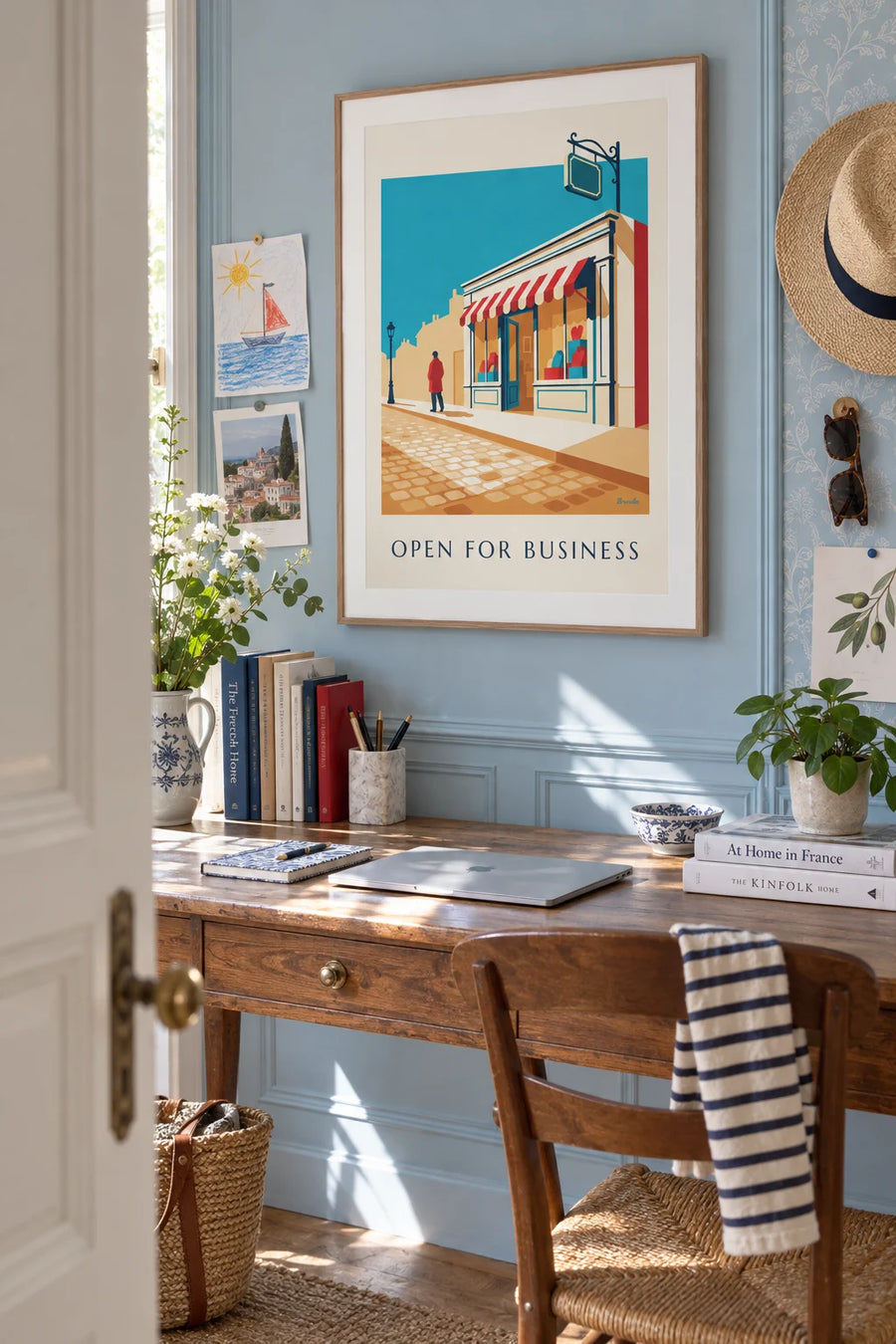 Poster of a neighborhood grocery storefront, “Open for business”: framed on the wall