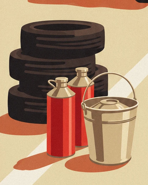 The stacked black tyres, 2 red cans and metal bucket on the pale ground