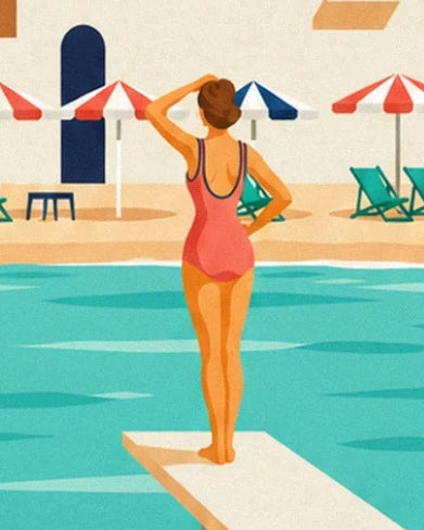 A woman seen from behind in a coral swimsuit on the diving board, facing the parasols