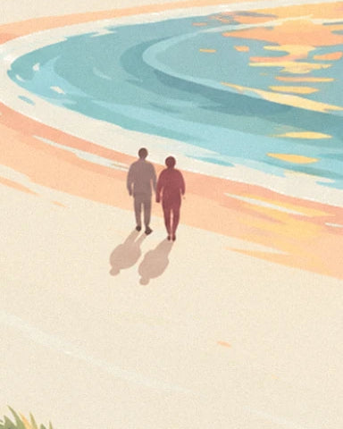 A couple holding hands on the pink sand beside the turquoise water