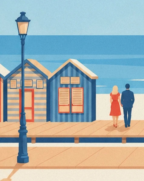 A couple beside the blue beach huts and a street lamp on the Deauville boardwalk