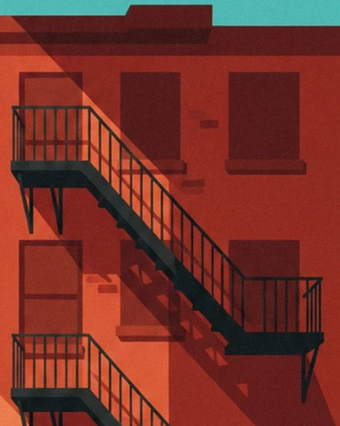 The black metal stairs in front of the dark windows of the orange façade