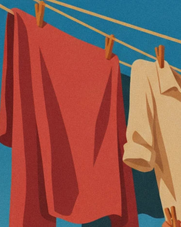 A red sheet and cream shirt pegged to the washing lines with wooden pegs