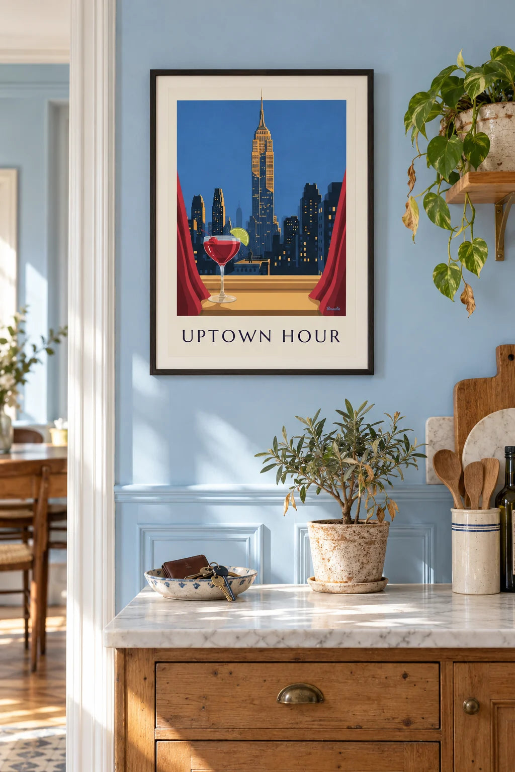 Red cherry cocktail facing the Empire State Building poster on the wall