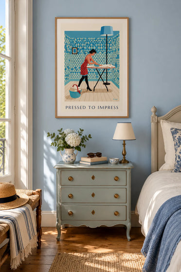 Poster of a pin-up ironing a shirt on her ironing board: framed on the wall
